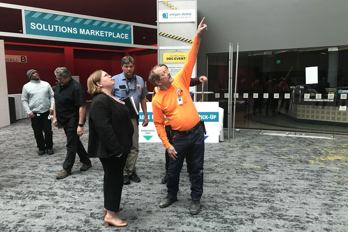 Metro Councilor Christine Lewis speaks with a contractor at the Oregon Convention Center